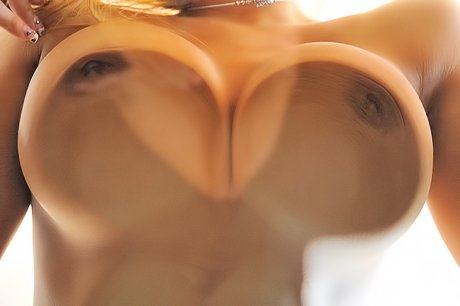 Big boobs blonde twists her nips and fucks her pussy with a glass toy