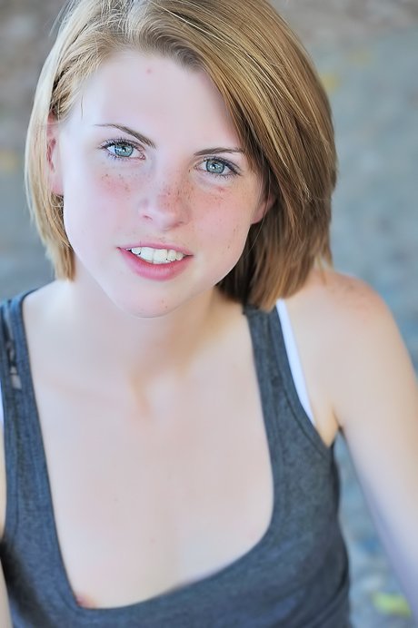 Professional pleaser with short hair and cute face shows her small boobs