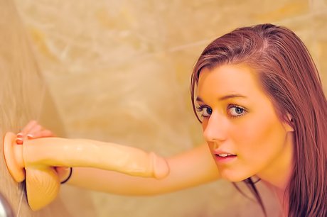 Young beauty worships a suction cup dildo in a wild solo gallery