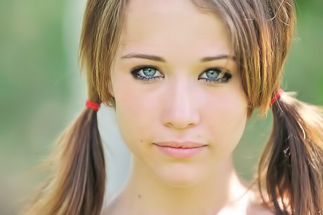 Pigtailed schoolgirl using a garden hose to fuck herself for the camera