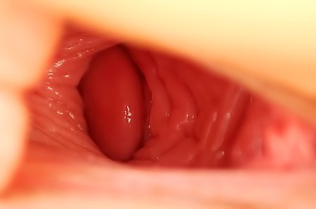 Ponytailed chick in a sexy skirt fisting her own slit on the floor