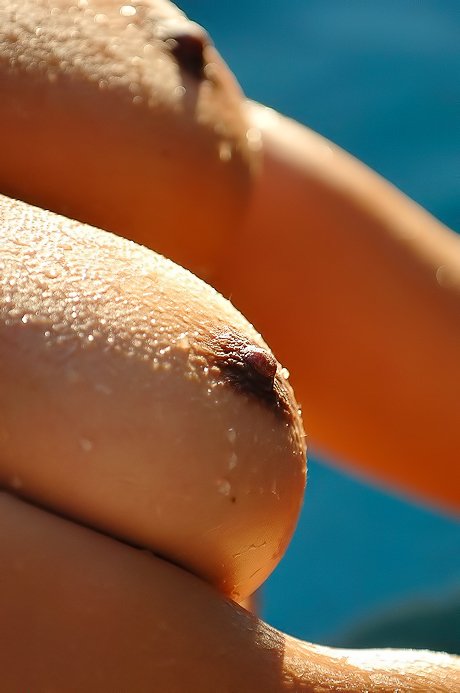 Purple dress babe shows her wet boobs and teases the camera as well