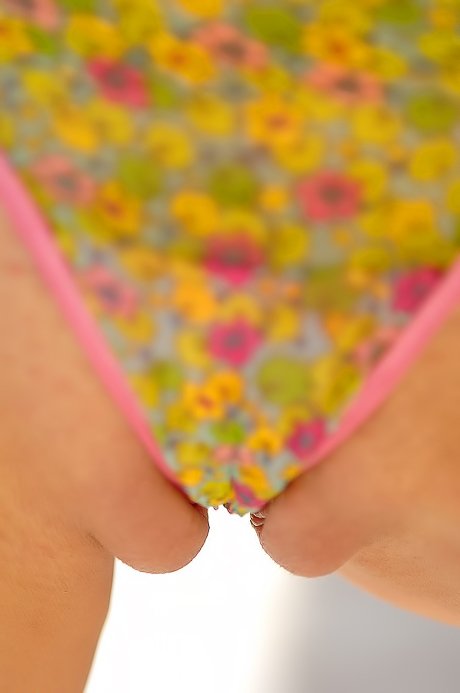 Colorfully dressed blonde fucking her own slit with a glass toy