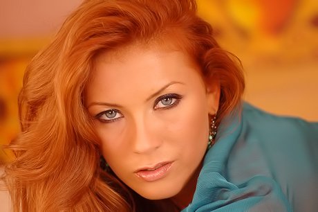 Redheaded babe takes off her see-through outfit and fingers her own slit