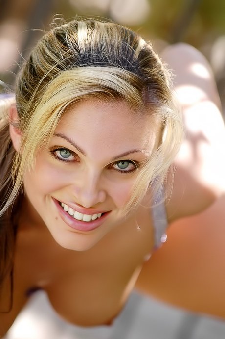 Blue-eyed blondie in sexy lingerie having lots of fun for the camera