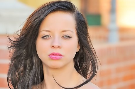 Lovely brunette lifts up her legs and teases her pussy for the camera