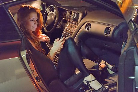 Party girl pulls down her leather pants to show that pussy in the evening